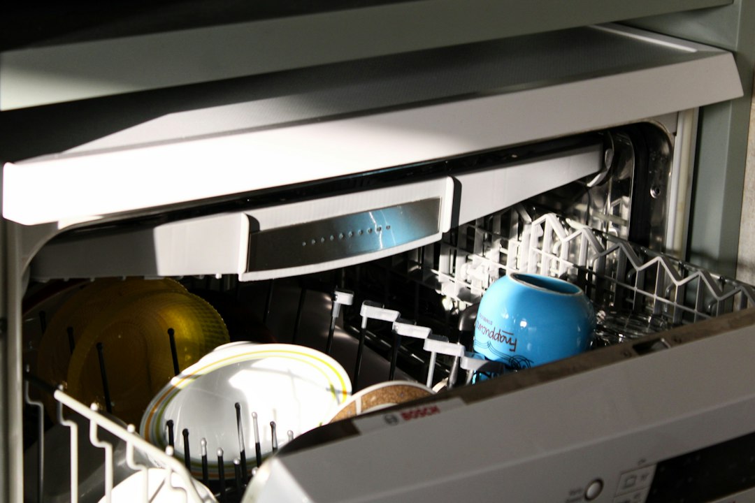 Open dishwasher with dishes on the rack in a home kitchen